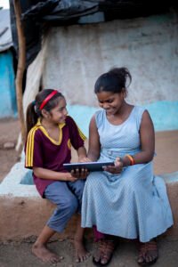 Two friends from the Korku tribe happily exploring and playing on a MediaTek-powered tablet in Madhya Pradesh.