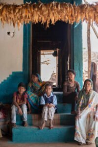 Five children walk along a road near That village in Tehri Garhwal, Uttarakhand, smiling and laughing as they look toward the camera on their way to school.