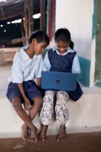 Two siblings from the Korku tribe in Madhya Pradesh learning together on a MediaTek-powered laptop.